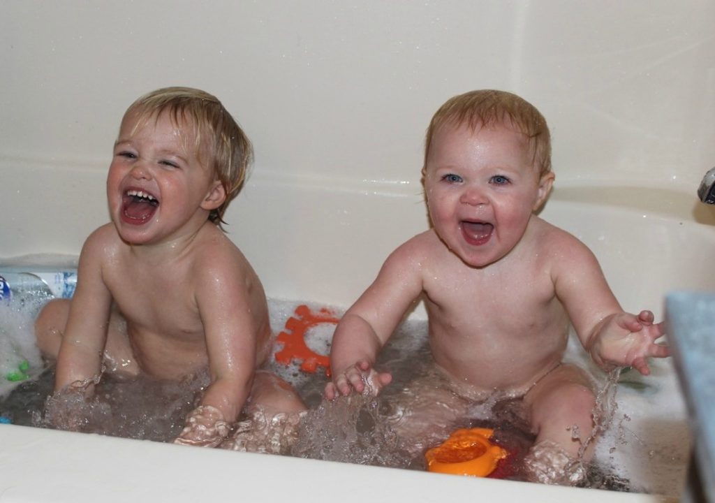 two cute babies in the bath